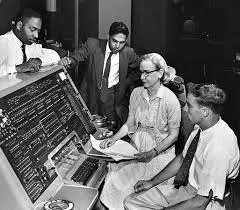 Black and white photo of Grace Hopper debugging a computer