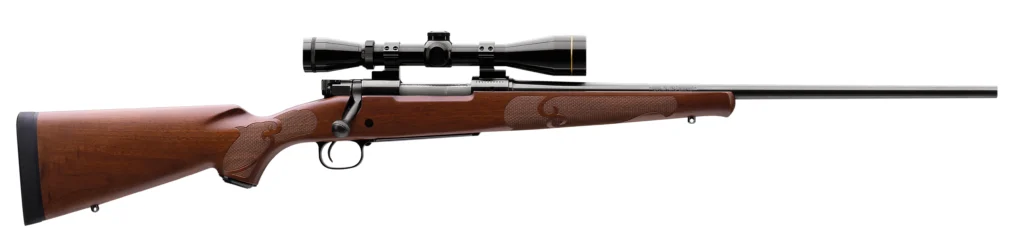 A classic Winchester Model 70 Featherweight rifle with a traditional wooden stock and a mounted scope, presented on a clean white background.